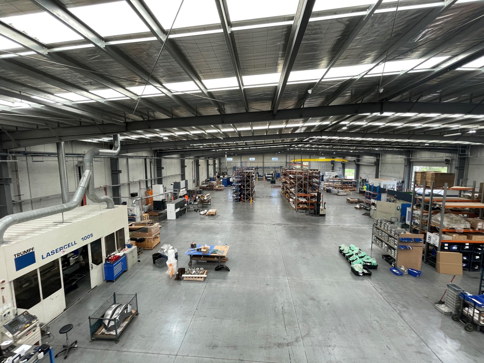 Large Laser 3D manufacturing facility showing production floor, machinery and organised fabrication workflow.