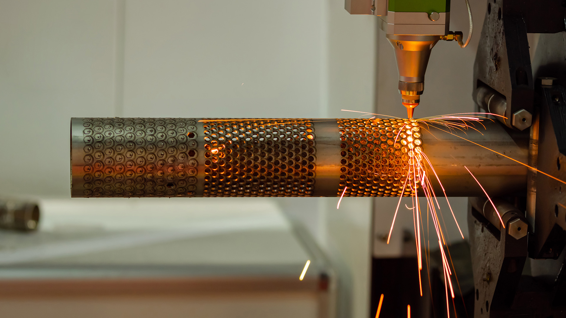 Tube laser cutting machine perforating metal pipe with high-precision sparks