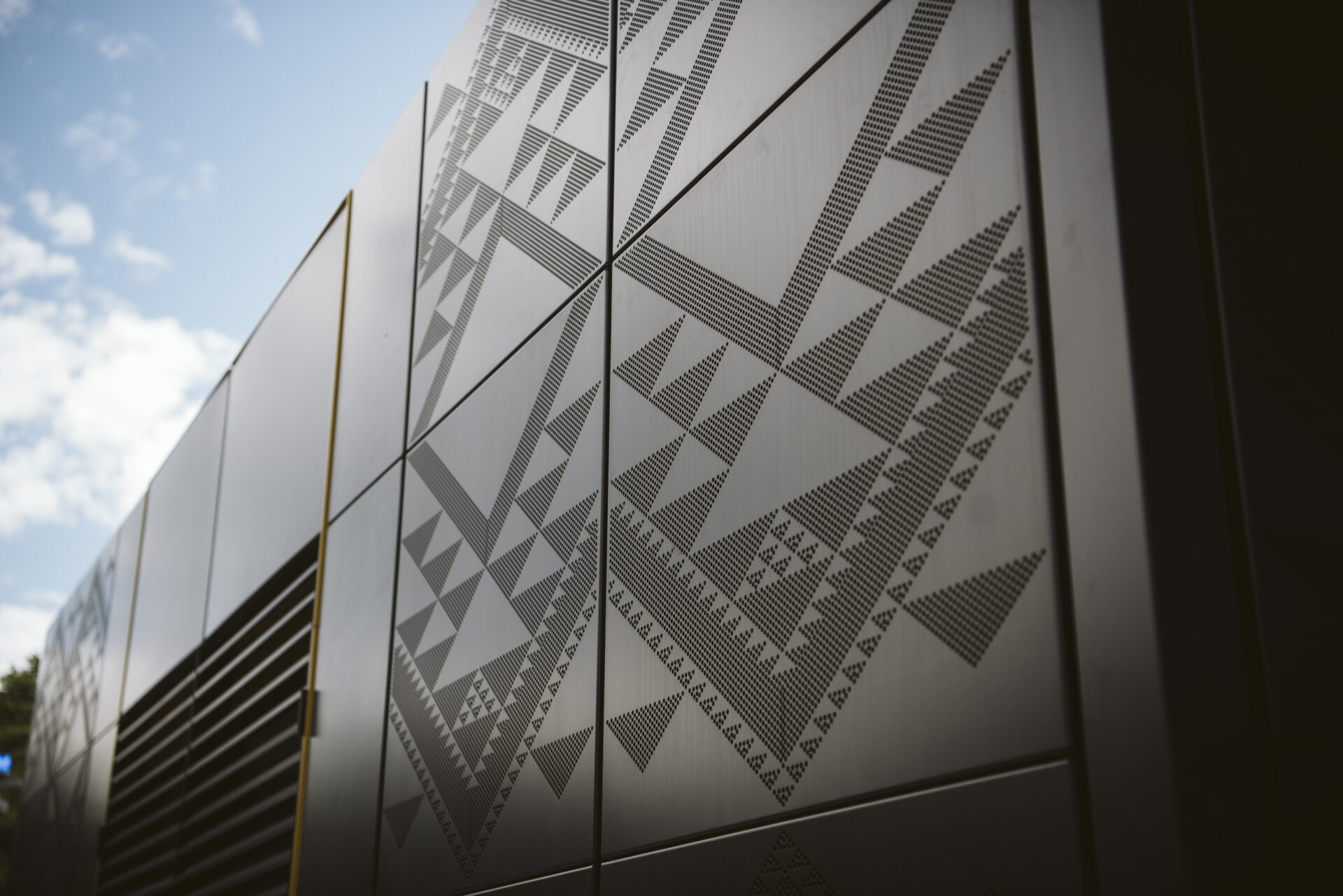 Close-up of laser-etched geometric patterns on metal panels showcasing Laser 3D’s precision engraving