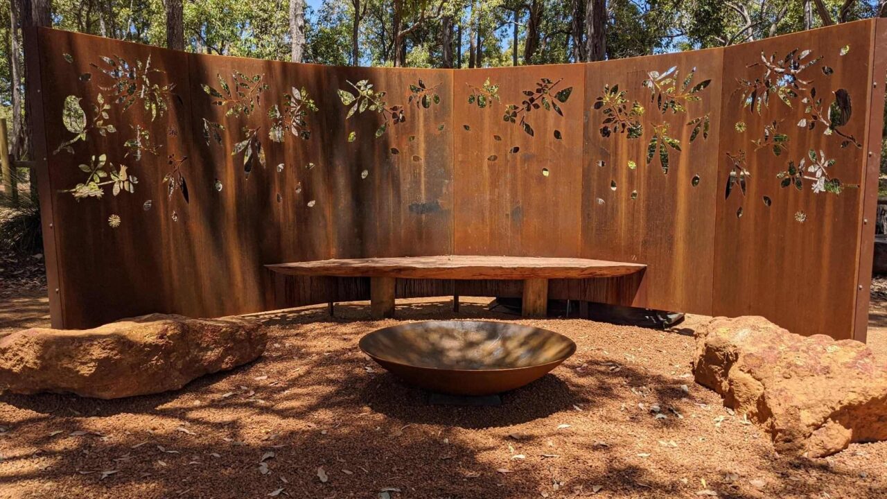 Decorative rust-coloured metal screen with nature patterns created using precision laser cutting