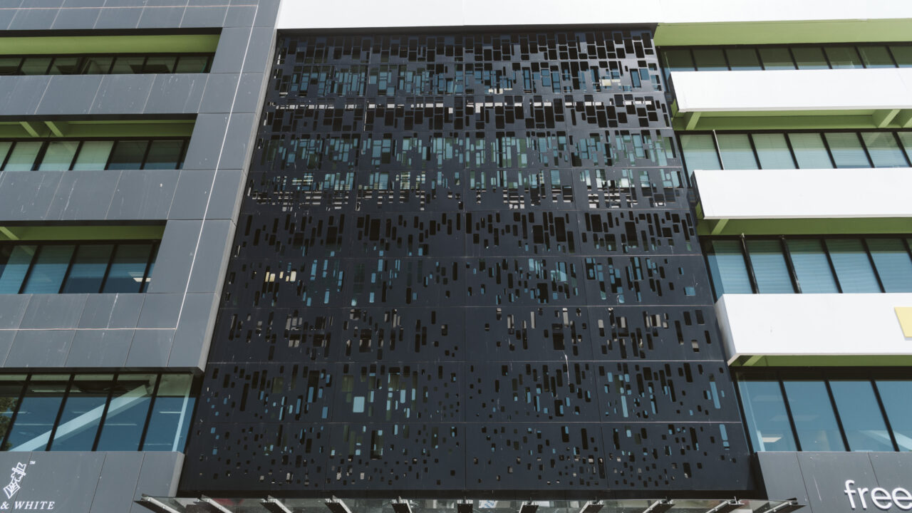 Modern building facade featuring custom laser-cut metal panels fabricated by Laser 3D