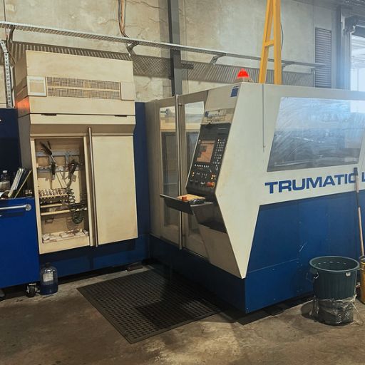 A Trumpf 3050 laser cutting machine in a warehouse.