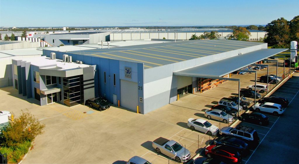 A very large warehouse and attached office as seen from above.