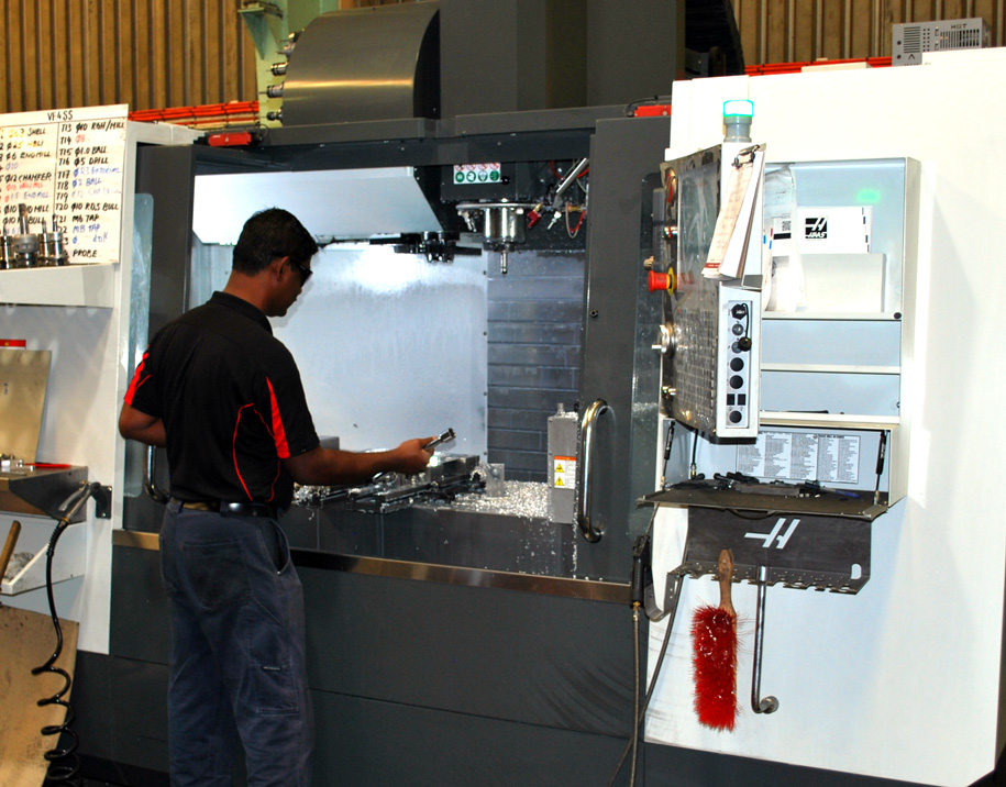 Someone operating a CNC machine.